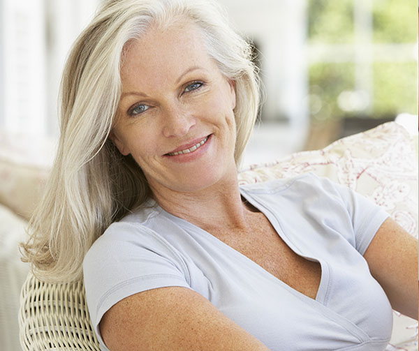 Smiling middle aged woman hormone replacement therapy Omaha